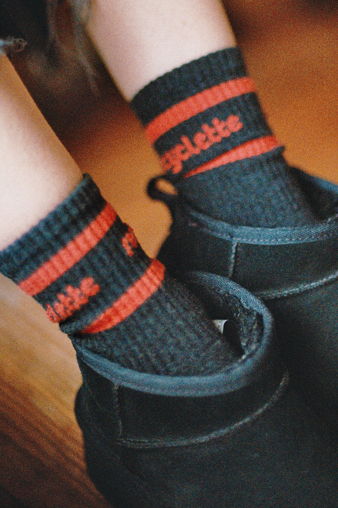 Nos chaussettes Recyclette rouge sur noir, portées avec des bottines noires.