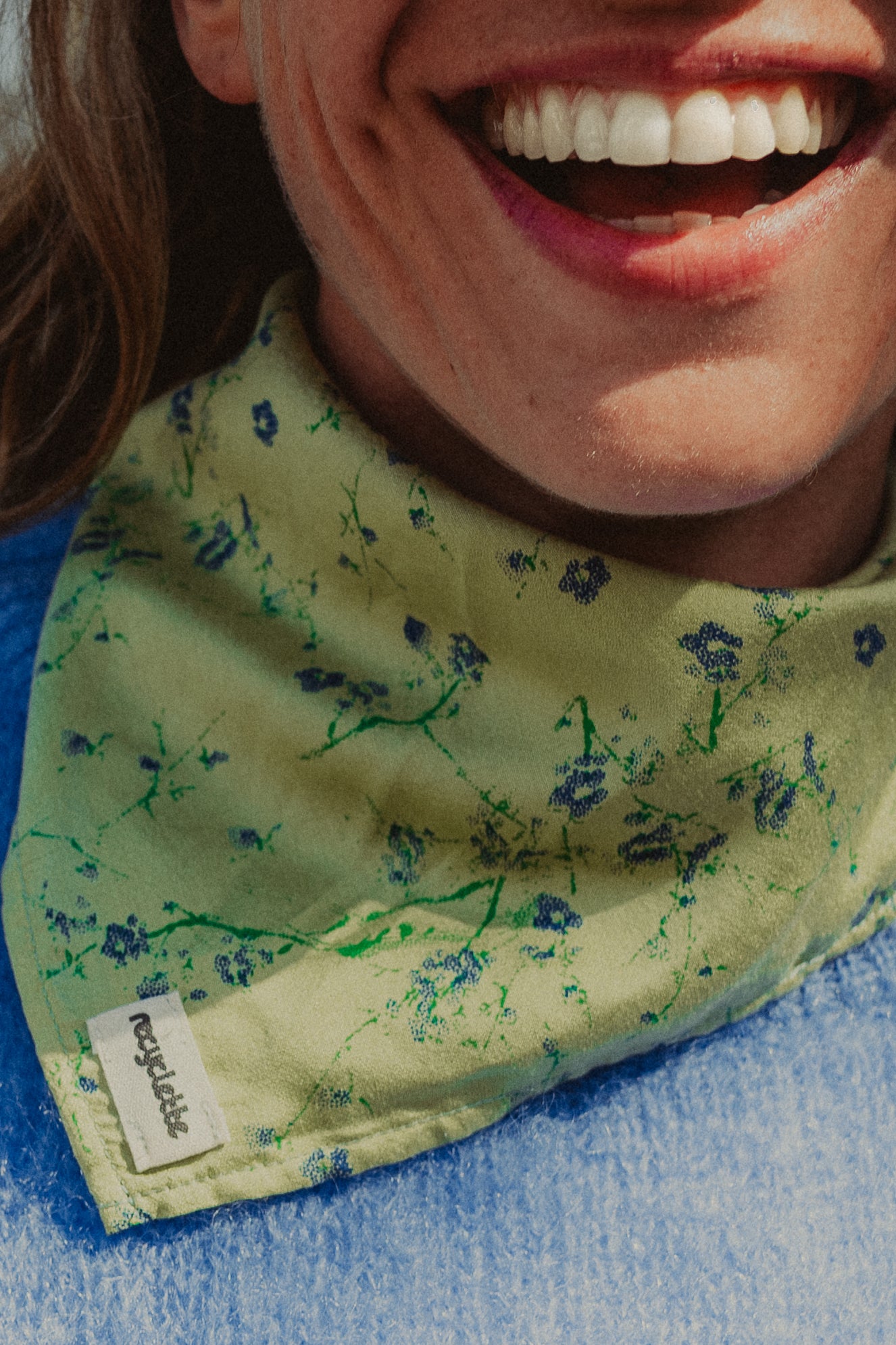 Foulard vert fleuri attaché au cou